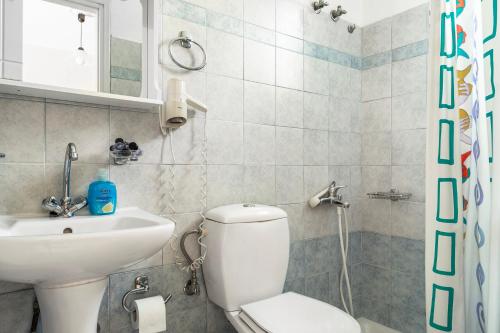 a bathroom with a toilet and a sink at Daratos studio 4 in Kefallonia