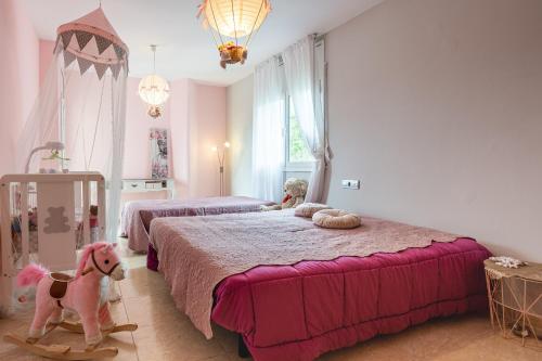 a bedroom with two beds with stuffed animals on it at Villa Yulia in Vidreres