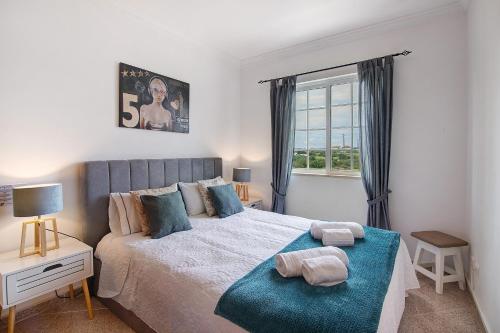 a bedroom with a large bed and a window at Villa Martina in Albufeira