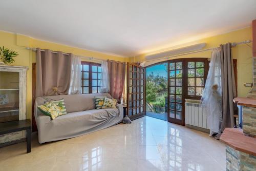 a living room with a couch and some windows at Lemon Green in Celle Ligure