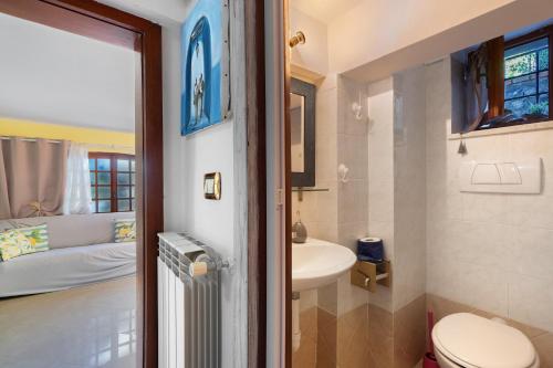 a bathroom with a toilet and a sink in a room at Lemon Green in Celle Ligure