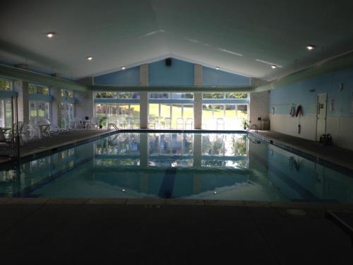 a large swimming pool in a large building at Eagle Village Resort & Chalet in Bushkill