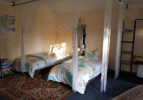a bedroom with two beds with curtains at Ferienhaus Fechter in Lanz