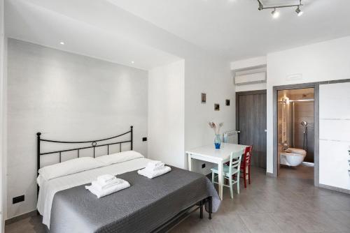 a bedroom with a bed and a desk and a bathroom at Ce Tour - Cetara Guest House in Cetara