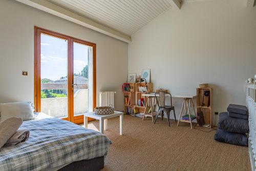 a bedroom with a bed and a window at Maison dans la Drôme Piscine privée in Montélimar