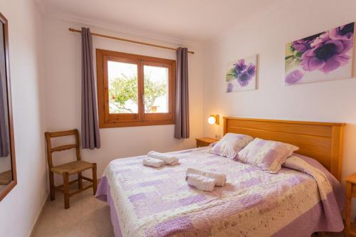a bedroom with a bed with two towels on it at Villa Loes in Menorca
