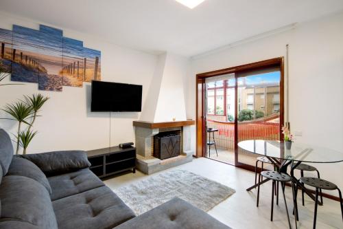 a living room with a couch and a fireplace at Barrinha Beach in Esmoriz