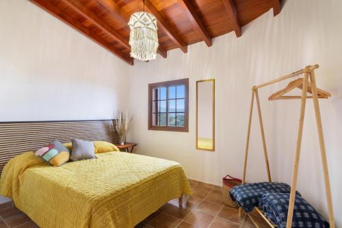 a bedroom with a bed and a wooden ceiling at Retiro Canario in Santa Brígida