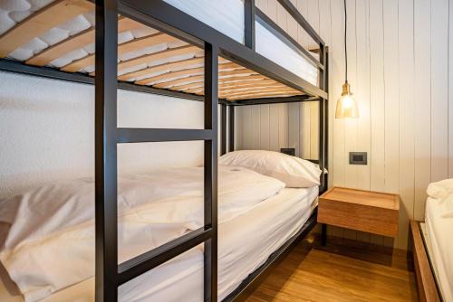 a bunk bed in a room with a bed sidx sidx sidx at Maso Rapunzel in Peio