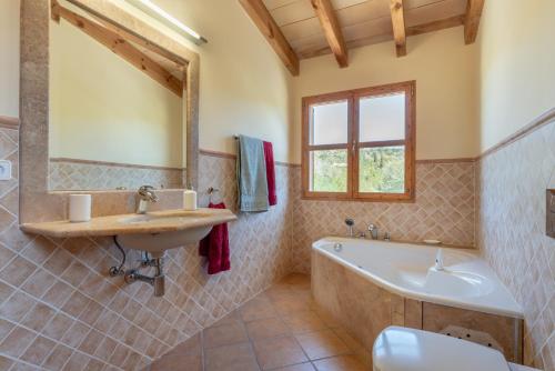a bathroom with a tub and a sink and a bath tub at Son Forte Nou in Artá