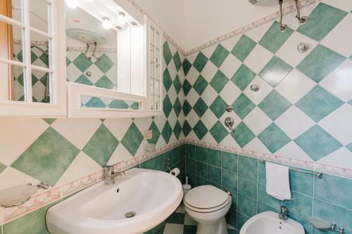 a bathroom with a sink toilet and a mirror at Da Giovanni A Custonaci in Custonaci