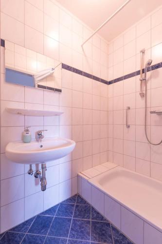 a bathroom with a sink and a bath tub at Appartment Isabelle - Kamille in Lake Pressegg