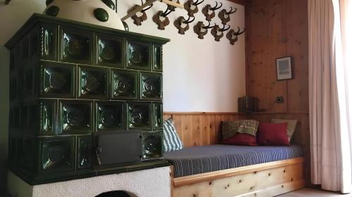 a room with a bed and a shelf with vases at Ferienhaus Roman in Hinterstoder