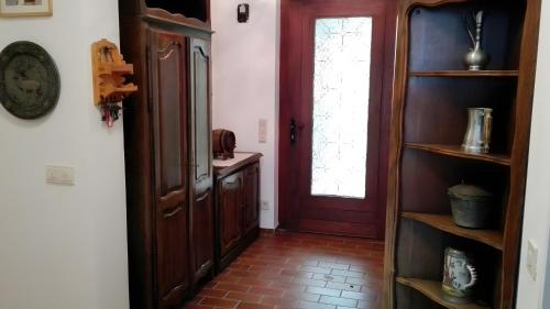 a hallway with a red door and a shelf at Ferienhaus Roman in Hinterstoder