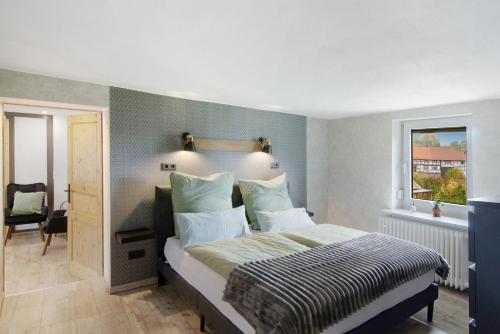 a bedroom with a bed and a window at De Lüttje Utkiek in Bühren