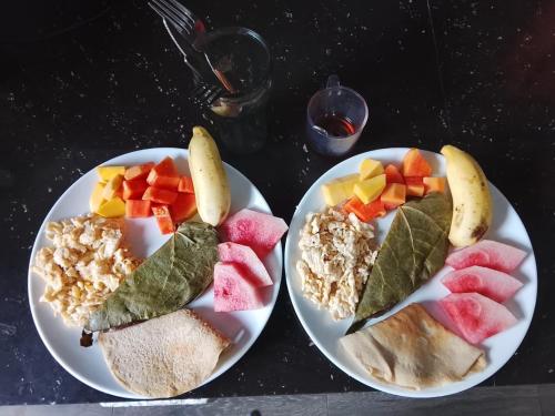 two plates of food with fruits and vegetables on them at Saha surf camp lesson booking only in Pottuvil