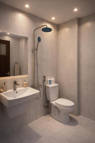 a bathroom with a toilet and a sink at Dreamora Centre Hotel in Hanoi