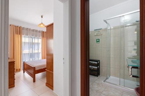 a bathroom with a shower and a sink at Casa De Pardal in Quarteira