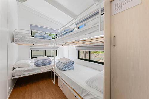 a small room with two beds and a window at Rivergardens Holiday Park Mildura in Gol Gol