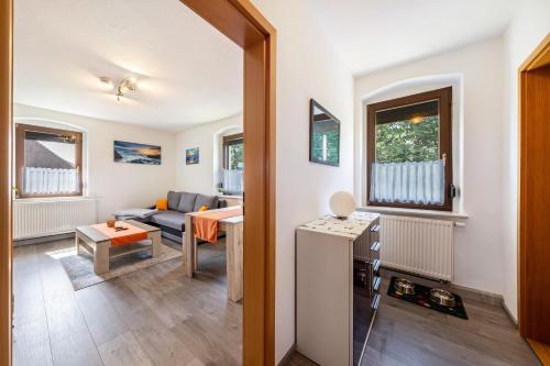 a living room with a couch and a table at Freundliche 50m² Ferienwohnung in Sonnenberg