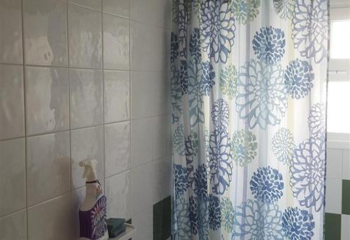 a shower curtain in a bathroom with a window at Beach apartment in Los Cristianos in Los Cristianos