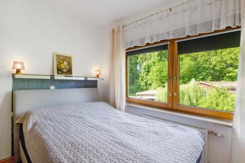 a bedroom with a bed and a large window at Ferienwohnung Gabi in Malchow