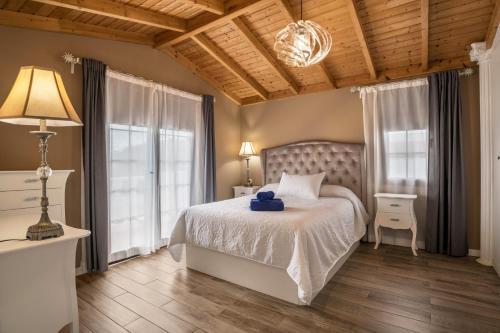 a bedroom with a bed and a lamp and windows at Villa María in Tinajo