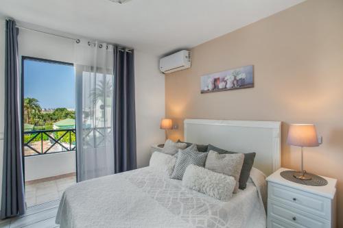 a bedroom with a bed and a balcony at Great Bungalow Maspalomas in Maspalomas