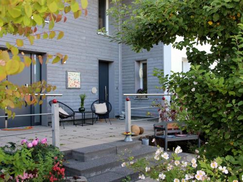 a patio with a table and chairs on a house at Ferienwohnung Auf Dem Schönen Felde in Brilon