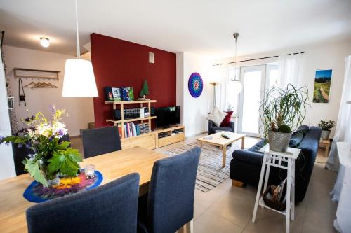 a living room with a dining table and a living room at Ferienwohnung Auf Dem Schönen Felde in Brilon