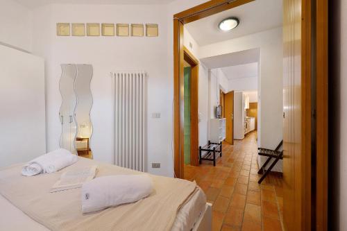 a bedroom with a bed with two towels on it at Villa G By Immobilux in Nago-Torbole
