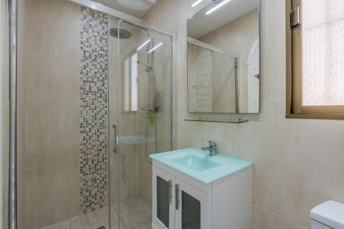 a bathroom with a sink and a glass shower at Casa Romantica in Salobreña