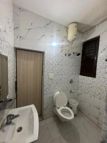 a bathroom with a toilet and a sink at City Palace in Zirakpur