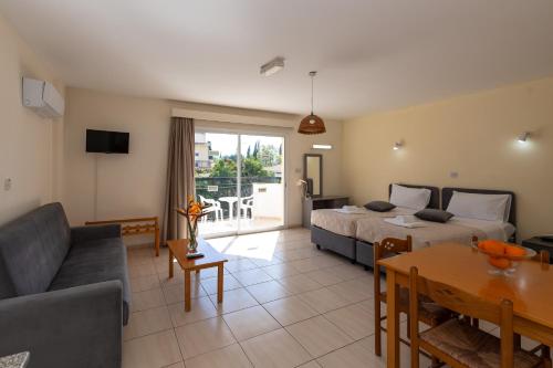 a living room with two beds and a couch at Mariela Hotel Apartments in Polis Chrysochous