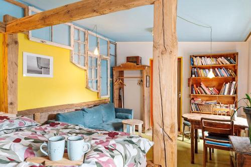 a bedroom with a bed and a dining room at Fuchsbau In Der Ktv in Rostock