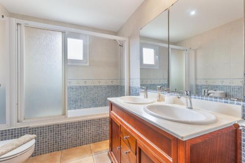 a bathroom with two sinks and a toilet at Villa Atlantic Ocean Private Pool in Corralejo