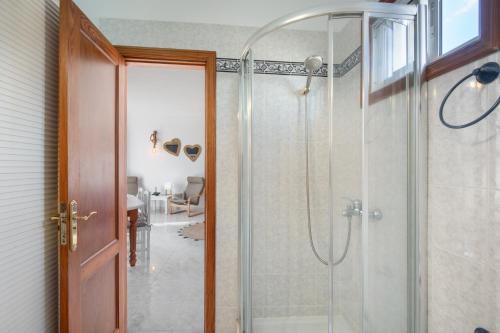 a bathroom with a shower with a glass door at Viento de Sal in Mazo