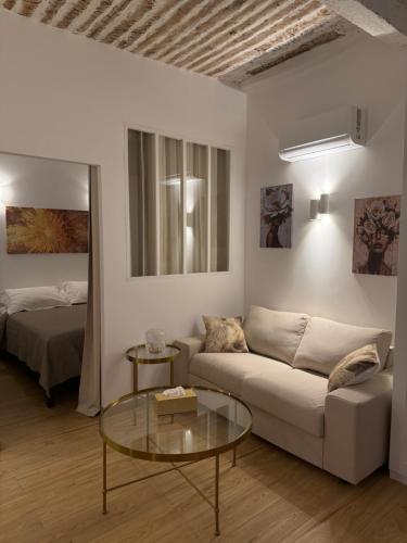 a living room with a couch and a bed at Très Grand studio neuf 50 m du port Lovely charrons 2 in Saint-Tropez