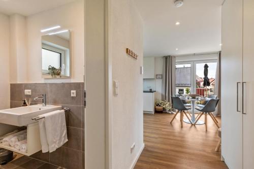 a bathroom with a sink and a mirror at Fewo Parkside S4 - 8Min Legoland in Günzburg