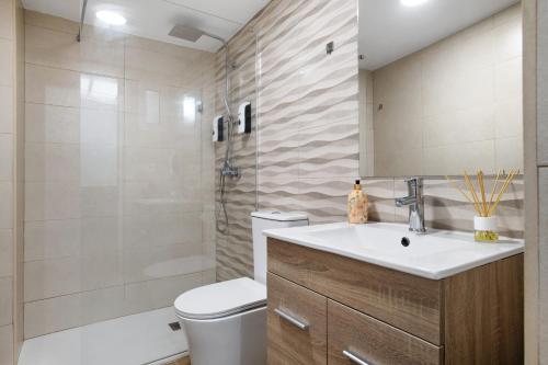 a bathroom with a sink and a toilet and a shower at Villa Españolillas in Olvera