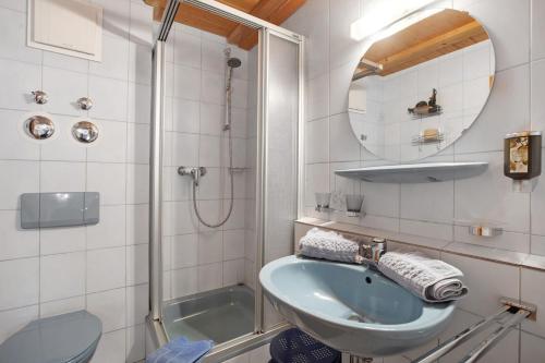 a bathroom with a sink and a shower at Gästehaus Klingele in Todtmoos