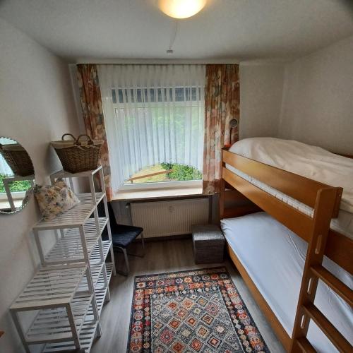 a small room with a bunk bed and a window at Ferienhaus Hahnenklee in Goslar