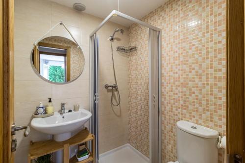 a bathroom with a shower and a sink and a toilet at Surf House Gama in Gama