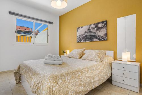 a bedroom with a bed and a window with the eiffel tower at La Octava Isla in Puertito de Güímar