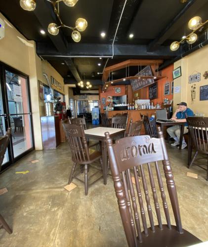 a restaurant with a table with a sign on it at Stonestown Suites in Balulang