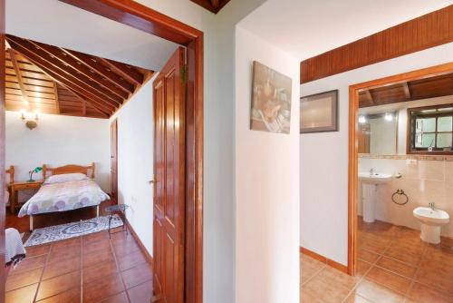 a bathroom with a bed and a sink in a room at El Morro in Tijarafe