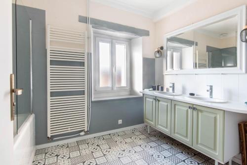 a bathroom with a sink and a shower at La ferme du château in Venon