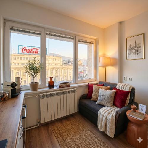 a living room with a couch and a window at Prime Main Square Location in Skopje