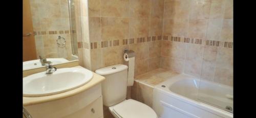 a bathroom with a toilet and a sink and a tub at Escapada Ideal en Oropesa in El Borseral