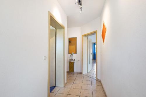 a hallway with white walls and a tile floor at Ferienwohnung Walter in Ellenbach
